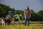 Woman in hay field with dog